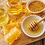 Honey and Diabetes: What Actually Happens to Your Blood Sugar Assorted honey jars, honeycomb, bee pollen, lavender, and a wooden honey dipper arranged on a rustic wooden tray.