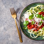 8 Easy Ways to Sneak Veggies Into a Diabetes-Friendly Diet Zucchini noodles topped with marinara sauce and basil.