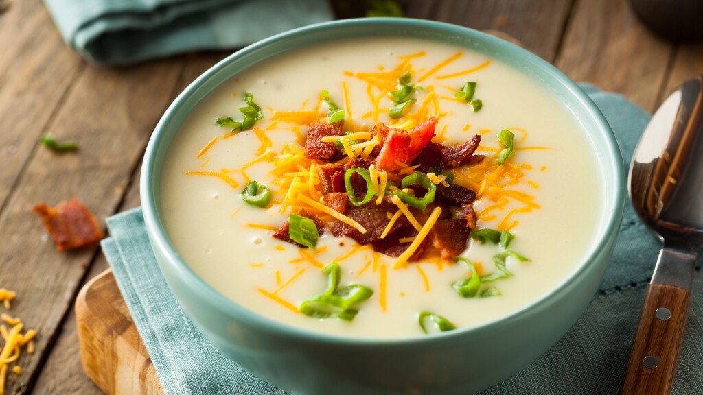 Creamy soup topped with bacon, cheese, and green onions.
