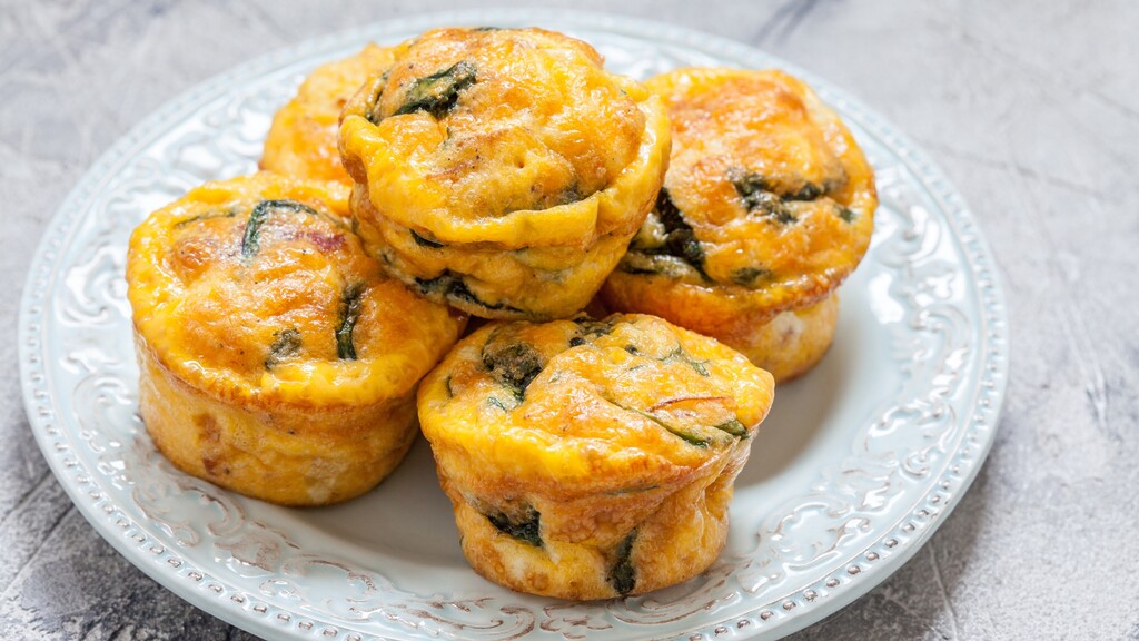 Mini egg cups with vegetables on a plate.