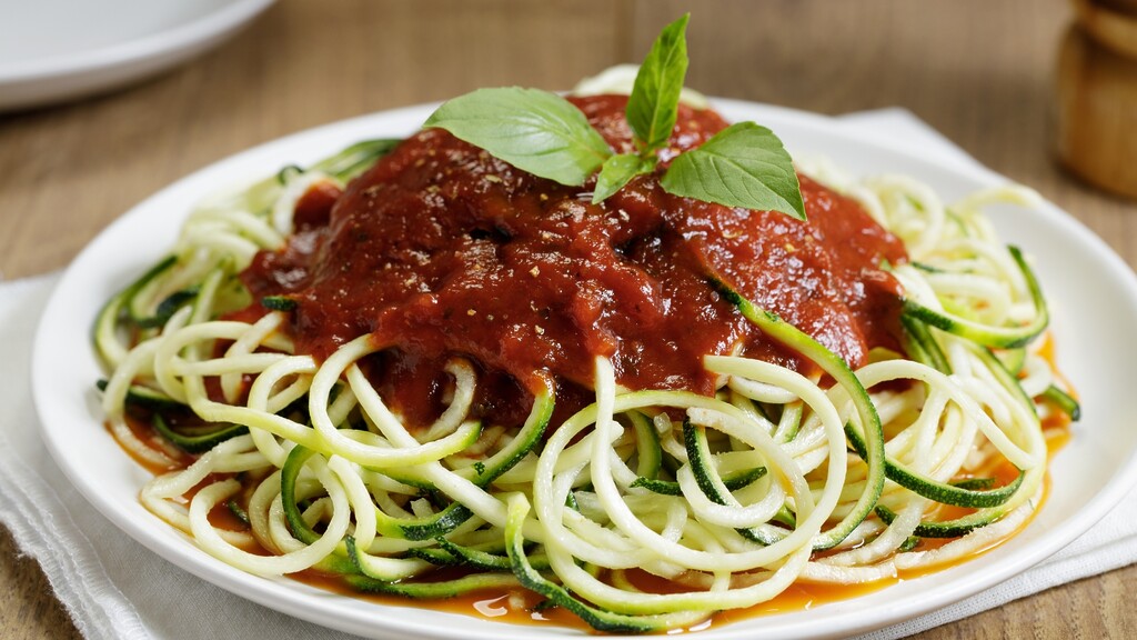 Zucchini noodles with tomato sauce, basil, and grated cheese.