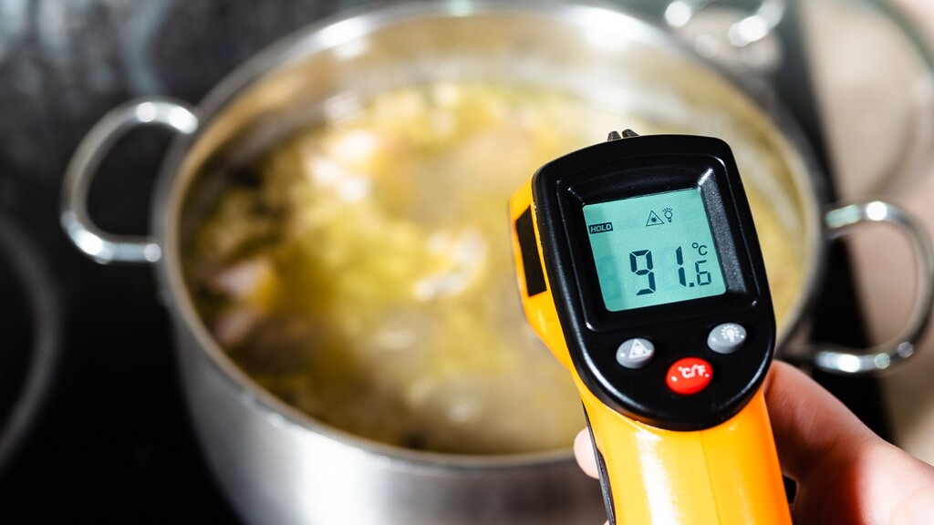Digital thermometer checking the temperature of a pot.