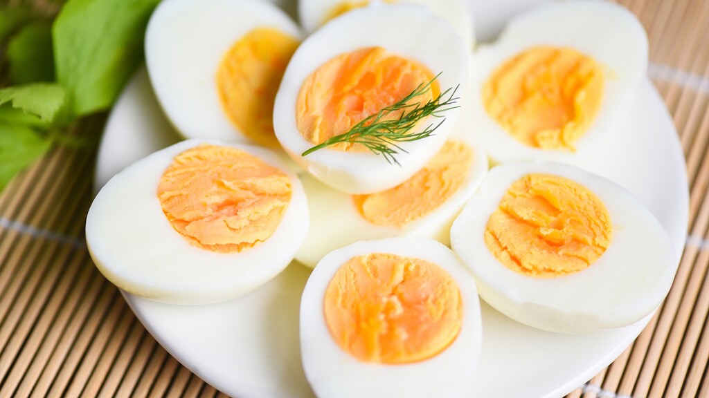 Hard-boiled eggs sliced in half on a plate.