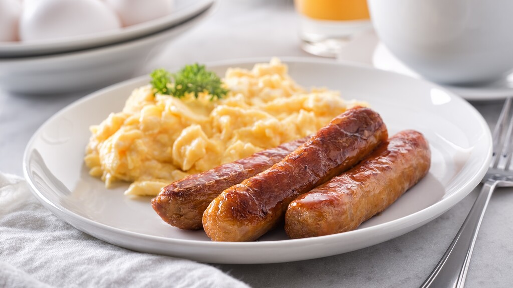 High-protein breakfast plate with scrambled eggs and turkey sausage.