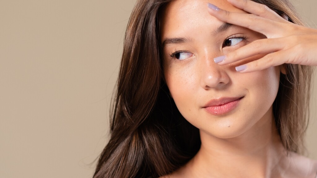 Close-up of a woman with healthy glowing skin, highlighting a natural youthful complexion.