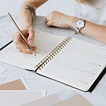 The 5-Step PCOS Self-Care Checklist for a Calmer Body Person writing in a planner on a marble table.