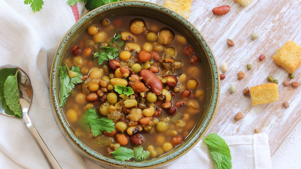Bowl of mixed bean soup with herbs.