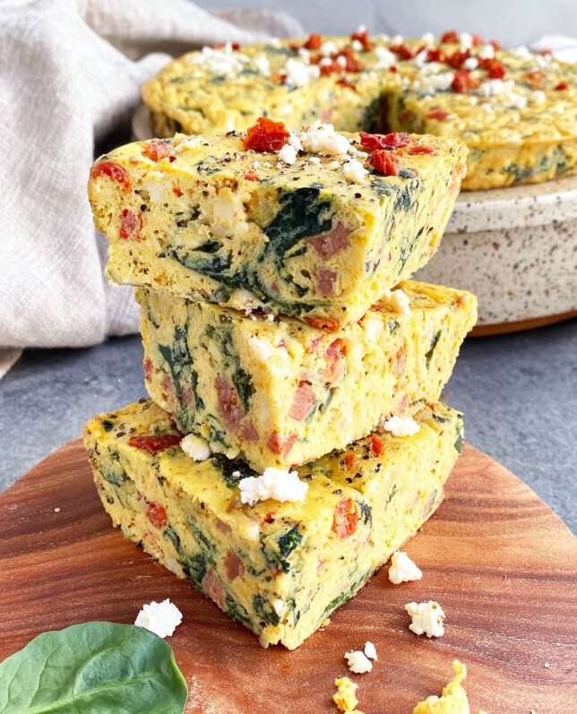 Thick squares of the breakfast bake stacked together, ready for storage or individual serving