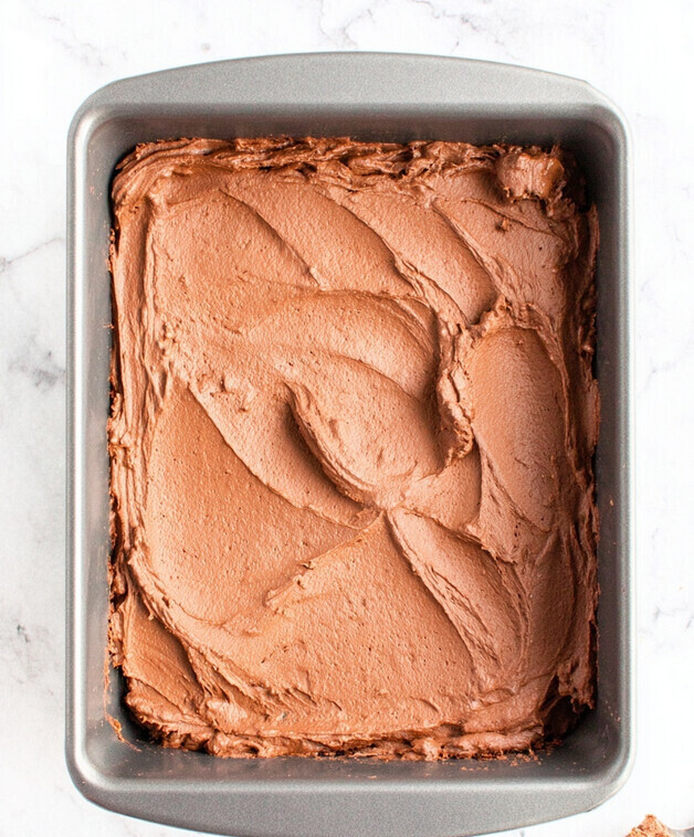 Keto Chocolate Lasagna - spreading the rich, dark chocolate mousse layer evenly over the white cheesecake layer in the pan